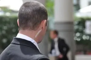 Security guard wearing a radio earpiece.