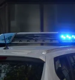 A blue police vehicle flashing lights.